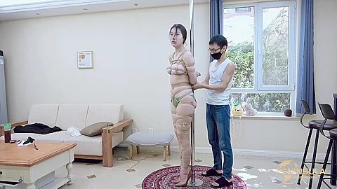 Tied to a pole with dildo gag